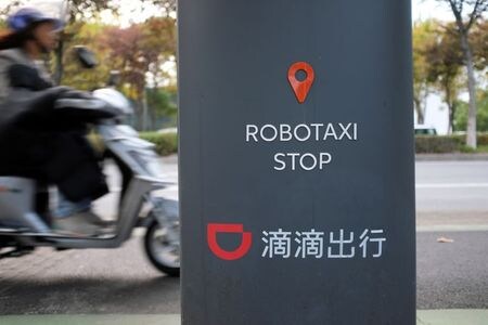 　１１月３０日、中国交通運輸省は、配車サービス業界のドライバーの権利保護に向け新たなルールの概要を発表した。企業側に社会保険の提供と利益の公開を求めた。滴滴の看板、上海で昨年１０月撮影（２０２１年　ロイター／Yilei Sun）
