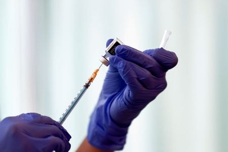 FILE PHOTO: A medical worker fills a syringe with a dose of the Pfizer-BioNTech coronavirus disease (COVID-19) vaccine as Japan launches its inoculation campaign, at Tokyo Medical Center in Tokyo, Japan February 17, 2021. Behrouz Mehri/Pool via REUTERS/Fi