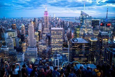 FILE PHOTO: People enjoy the Manhattan skyline during sunset, from the Top of the Rock observation deck, at Rockefeller Center, in New York, U.S., June 28, 2022. REUTERS/Athit Perawongmetha