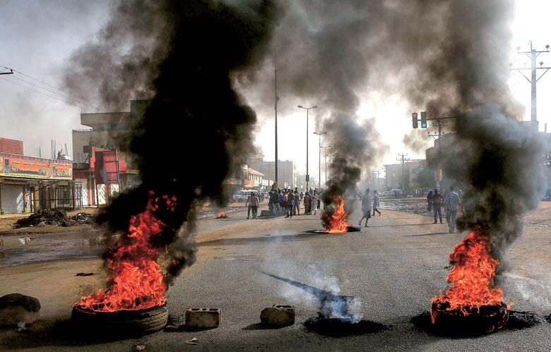 タイヤを燃やしてバリケードを張るデモ隊（6月3日、ハルツーム）　REUTERS