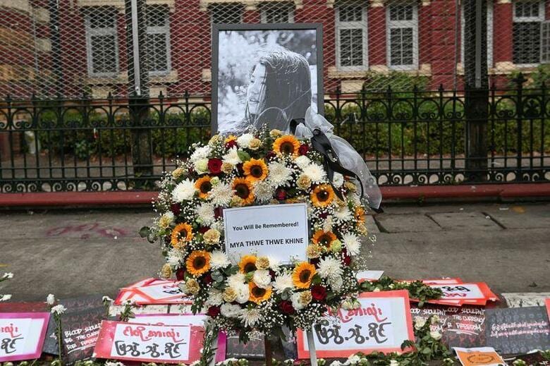 国軍によるクーデターへの抗議活動が続くミャンマーで、頭部を撃たれ入院していた20歳の女性が死亡した。写真は死を悼む花束が添えられた女性の遺影。2月18日、ヤンゴンで撮影。（2021年　ロイター／ストリンガー）