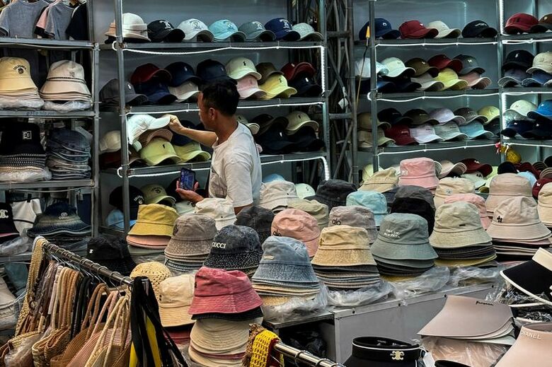 写真はベトナム・ハノイ郊外の市場で買い物をする男性。２５日撮影。REUTERS/Francesco Guarascio