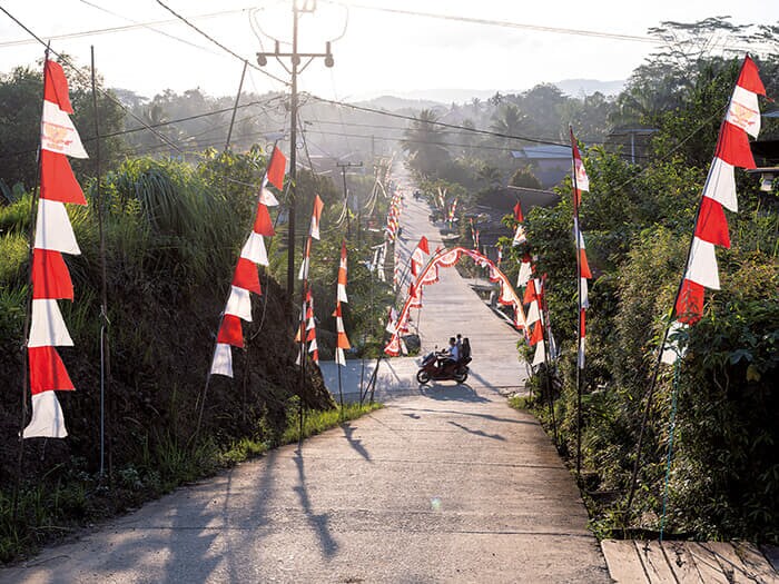 インドネシア国旗の赤と白の旗が掲げられたセパク・ラマ村の通り