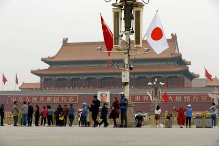 People visit the Tiananmen Square decorated with Chinese and Japanese flags ahead of Japan\'s Prime Minister Shinzo Abe\'s visit, in Beijing, China October 25, 2018.  REUTERS/Thomas Peter