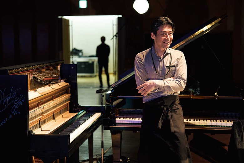 「かてぃんピアノ」（左）の仕掛けにも関わる按田泰司　TORU YAGUCHI FOR NEWSWEEK JAPAN