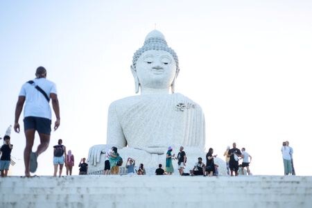 　１０月３１日、タイ政府はインドと台湾からの入国者のビザ（査証）を１１月から２０２４年５月まで免除する。写真はプーケットの大仏と観光客。７月撮影（２０２３年　ロイター/Jorge SIlva）