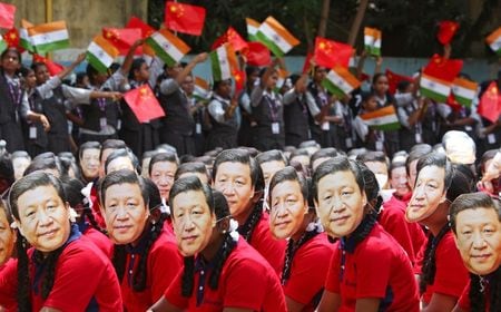 インド政府は、中国と香港の新たな「外国ポートフォリオ投資家（ＦＰＩ）」に対する監視を強化する規制案を起草した。写真は中国・習近平国家主席の仮面をつけるインドの学生たち。２０１９年１０月１９日、モディ首相と習主席の非公式会談がチェンナイの学校で行われた（２０２０年　ロイター/P. Ravikumar）