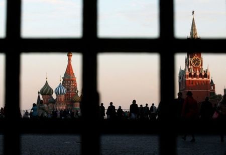 FILE PHOTO: Red Square, St. Basil\'s Cathedral (L) and the Spasskaya Tower of the Kremlin are seen through a gate in central Moscow, September 18, 2014. REUTERS/Maxim Zmeyev/File Photo