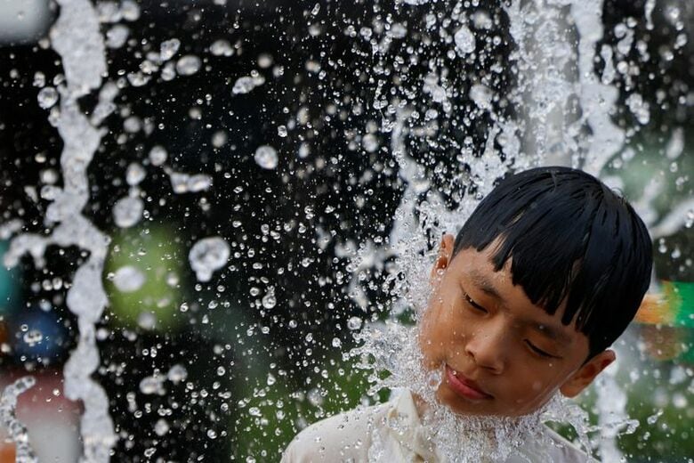 写真は噴水で涼む少年。7月31日、ソウルで撮影。 REUTERS/Kim Soo-hyeon