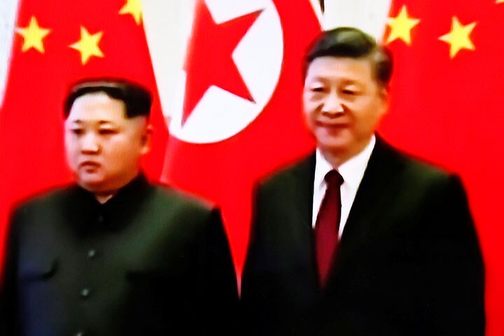 中朝首脳会談における金正恩委員長と習近平国家主席　Kim Hong-Ji-REUTERS