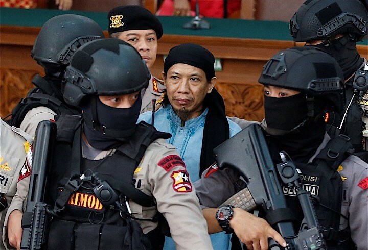 法廷内でも覆面部隊がアマン被告を取り囲んで警備にあたった。　Darren Whiteside-REUTERS
