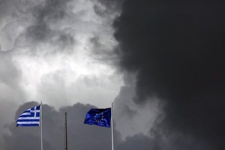 　５月４日、ギリシャと国際債権団の間で、年金や労働改革で意見の隔たりが依然として大きく、協議の行方が見通しにくくなっている。写真はＥＵ旗（右）とギリシャ国旗。アテネで３月撮影（２０１５年　ロイター／Kostas Tsironis）
