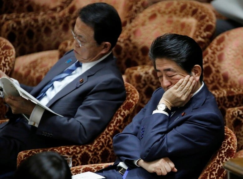 ３月１５日、安倍晋三首相（右）を脅かす政治スキャンダルの波紋が広がる中、「ソンタク（忖度）」として知られる日本の習慣が、その責任究明を複雑なものにしている。都内で２月撮影（２０１８年　ロイター/Toru Hanai）