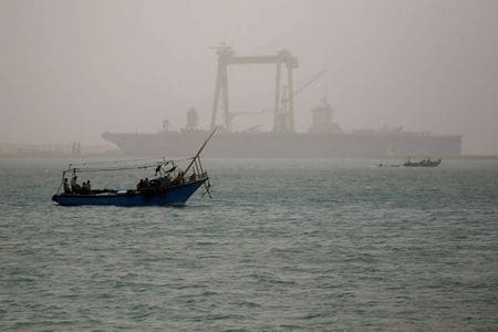A boat is seen on a dusty weather in Suez near the Suez Canal, Egypt March 24, 2021. REUTERS/Amr Abdallah Dalsh - RC2NHM9CSZAK