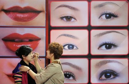 　中国では、若者の就職や収入への期待がしぼむ中、ＳＮＳ上で２０年前の高度成長期のファッションや文化を懐古する投稿が急増している。写真はモデルにメイクを施す美容師。２００９年４月、中国山西省の太原市で撮影（２０２５年　ロイター）