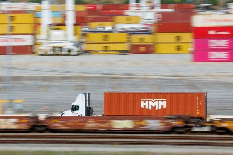 米カリフォルニア州ロサンゼルス港のターミナルで貨物を運ぶトラック。２月撮影。REUTERS/Mike Blake/File Photo