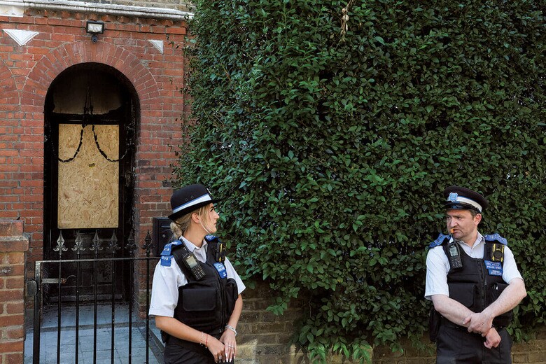 放火されたスターマー英首相私邸前で警戒する警察官　TOBY MELVILLEｰREUTERS