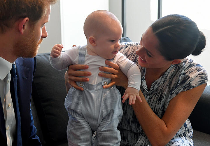 息子のアーチーをあやすメーガンとヘンリー王子（2019年の南アフリカ訪問時に撮影）　Toby Melville/Pool-REUTERS