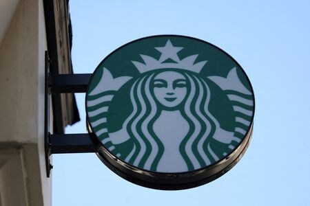 Starbucks logo is displayed above their cafe in London, Britain, August 13, 2024. REUTERS/Hollie Adams