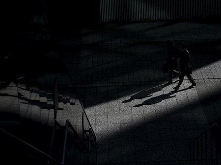　３月２４日、三菱商事は資源価格の低迷を踏まえ、チリ銅事業などで２０１６年３月期に総額４３００億円の減損を見込むと発表した。写真は１月２０日、都内ビジネス街を歩く男性たち（２０１６年　ロイター/Toru Hanai）