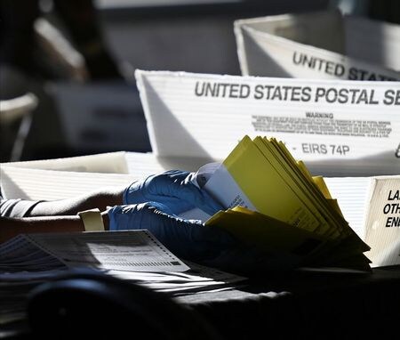 An employee of the Fulton County Board of Registration and Elections processes ballots in Atlanta, Georgia U.S., November 4, 2020. REUTERS/Brandon Bell