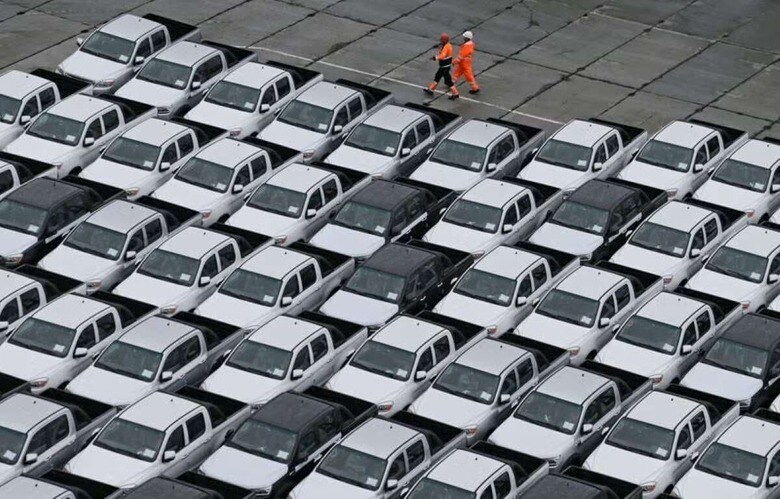 Workers walk past new Chinese cars unloaded from a ship at a commercial port in Vladivostok, Russia August 25, 2023. REUTERS/Tatiana Meel
