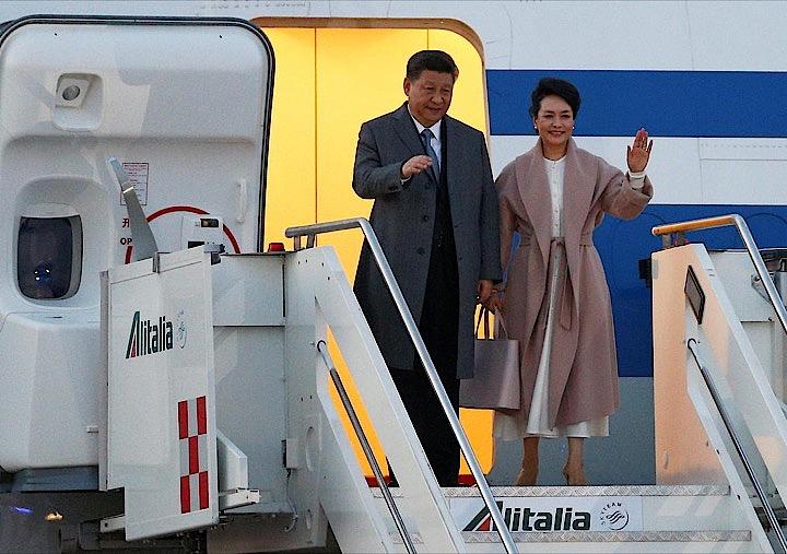 中国の習近平国家主席は、イタリアの首都ローマに到着した。中国が提唱する巨大経済圏構想「一帯一路」へのイタリアの参画に向けて、覚書を署名する見通し。彭麗媛夫人（右）と手を振る同国家主席（左）。ローマで撮影（２０１９年　ロイター／YARA NARDI）