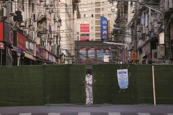 居住区との境界に設置されたフェンスに施錠する作業員（5月4日）　ALY SONGｰREUTERS