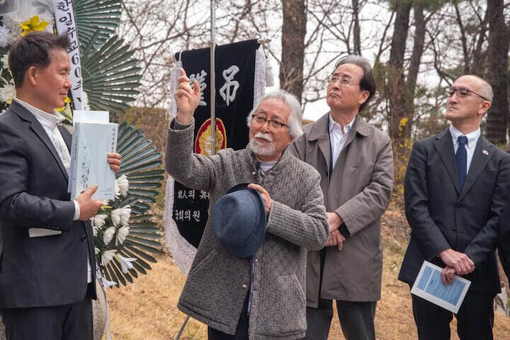 挨拶する富井正憲客員教授（中央、筆者撮影）