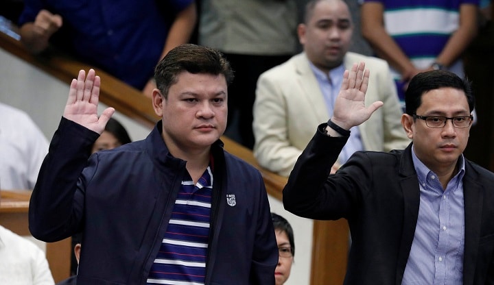 上院公聴会で宣誓するドゥテルテの長男パオロ、娘婿のカルピオ。麻薬取引疑惑で証言した（9月7日）　Erik De Castro-REUTERS