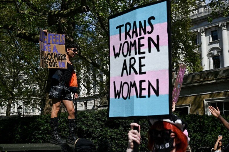 「トランス女性は女性である」と掲げるデモ参加者（4月19日、ロンドン）　CHRIS J RATCLIFFE―REUTERS