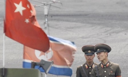 　９月２３日、中国政府は北朝鮮の６回目の核実験を受けた国連安全保障理事会決議に基づき、北朝鮮への石油精製品輸出の制限をはじめとする制裁措置を実行すると発表した。写真は中国との国境を警備する北朝鮮兵士。２０１３年６月撮影（２０１７年　ロイター/Jacky Chen）
