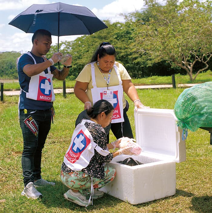 航空機で運ばれた狂犬病、百日咳など130回分の子供用ワクチンを荷ほどきするバランコミナス医療チームのメンバー