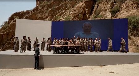 トルコの非合法組織クルド労働者党（ＰＫＫ）は１１日、イラク北部で式典を開き、ＰＫＫの幹部が武装解除の決定を宣言する声明を読み上げた。写真はイラクのスレイマニヤで行われた武装解除式典。同日撮影（２０２５年　ロイター/KURDISTAN WORKERS PARTY MEDIA OFFICE/Handout via REUTERS）