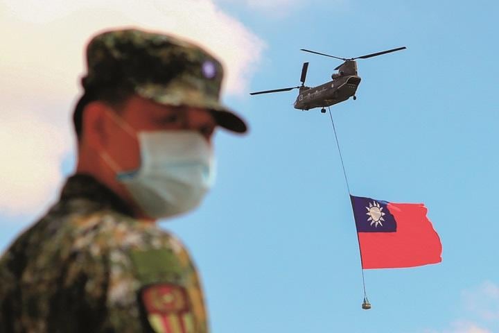 巨大な中華民国国旗をつり下げる台湾軍のヘリ（9月28日）CENG SHOU YIｰNURPHOTO/GETTY IMAGES