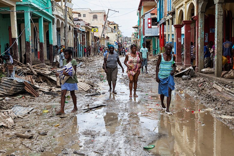 １０月７日、大型ハリケーン「マシュー」が直撃したハイチで死者数が８４２人に達した。写真はハリケーンが去った街の片付けをする人びと　REUTERS