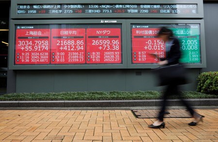 　１０月２９日、東京株式市場は強気の相場展開を続けており、日経平均株価は、約１年ぶりに一時２万３０００円を回復した。７月に都内の株価ボード前で撮影（２０１９年　ロイター／Issei Kato）