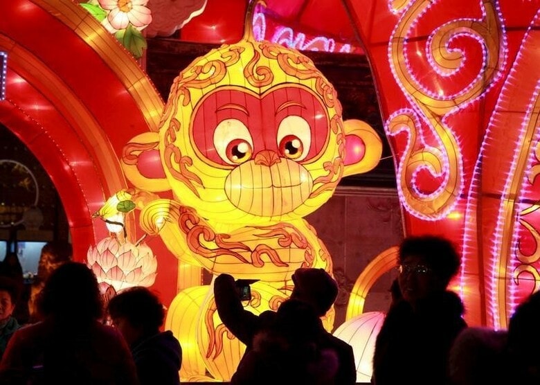 ２月２日、中国の景気減速は製造業に痛手を与えているが、同国に進出している外資系企業の中でもコーヒーショップ、ハンバーガーショップ、衣料品店などから聞こえる声は明るい。写真は南京で４日、中国の旧正月（春節）の到来を祝うサルのランタンを撮影する人。提供写真（２０１６年　ロイター）