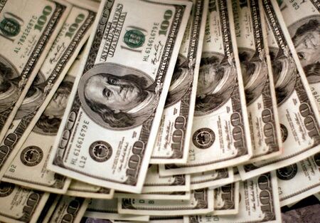 　米連邦準備理事会（ＦＲＢ）がハト派姿勢に転じたことで、来年はドル安が続くとの観測が強まってきた。ただ米経済の堅調さが、ドル売りを限定的にとどめてもおかしくない。写真は１００ドル紙幣。２００９年１１月、コロラド州の銀行で撮影（２０２３年　ロイター/Rick Wilking）
