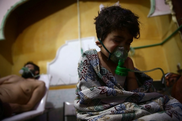 シリア軍に包囲された人道危機の町、東グータの病院で。傷ついた子供と男（2018年2月25日）　Bassam Khabieh-REUTERS