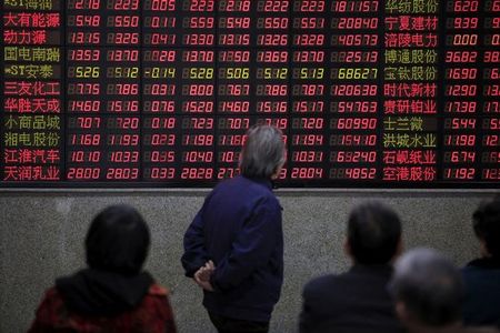 中国は上場廃止に関する監督管理強化措置を１２日に発表する。証券監督管理委員会（証監会）の呉清主席のインタビューを引用して新華社が同日報じた。写真は上海の証券会社で株価ボードを見る人たち。２０１６年３月撮影（２０２４年　ロイター／Aly Song）
