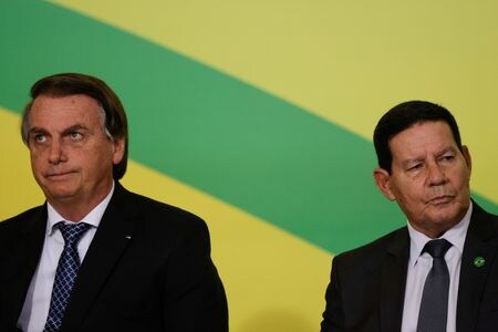 ブラジルのボルソナロ大統領（左）は２４日、ロシアのウクライナ侵攻を非難したモウラン副大統領を叱責し、東欧の危機について発言するの副大統領の仕事ではないと指摘した。写真は２０２１年１１月、ブラジリアで撮影（２０２２年　ロイター/Ueslei Marcelino）