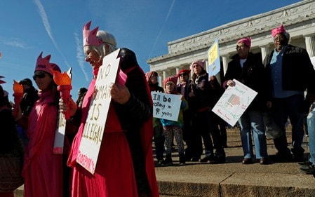Codepink activist Paki Wieland, dressed as Lady Liberty, participates in the Second Annual Women\'s March in Washington, U.S. January 20, 2018. REUTERS/Leah Millis