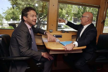 　５月６日、ユーロ圏財務相会合のデイセルブルム議長（写真左）は、ギリシャ支援で１１日合意の公算は小さいと述べた。写真右はサパン仏財務相。セーヌ川に浮かぶボートで同日撮影（２０１５年　ロイター／Philippe Wojazer）