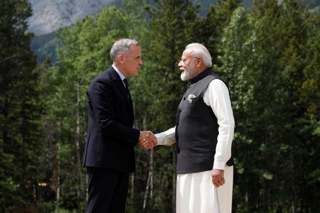 　インドとカナダは１３日、ニューデリーで外相会談を行い、両国関係の新たなロードマップで合意した。 写真はカナダのカーニー首相（左）とインドのモディ首相。カナダ・アルバータ州カナナスキスで６月撮影（２０２５年　ロイター／Amber Bracken）