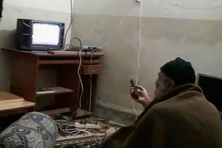 テレビを見るウサマ・ビンラディンを撮影した映像より（2010年）　REUTERS/Pentagon/Handout