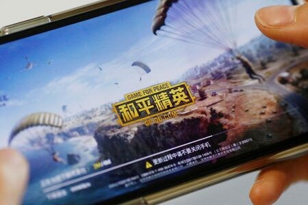中国は先週、ゲーム業界規制機関である国家新聞出版署（ＮＰＰＡ）を監督する共産党中央宣伝部の出版局局長、馮士新氏を解任した。状況説明を受けた関係者５人が明らかにした。写真は携帯電話の画面に映るゲーム。２０１９年５月撮影（２０２４年　ロイター／Florence Lo）