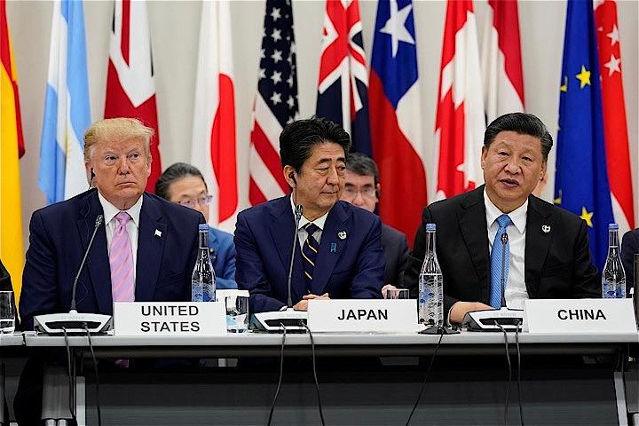 大阪で29日に行われた米中首脳会談では、米国による中国から3250億ドル規模の輸入品に対する25％関税の賦課が回避されたものの、両国の対立は長期化しそうだとの見方が専門家から提起されている。写真左からトランプ米大統領、安倍首相、習中国国家主席、28日撮影（2019年　ロイター/Kevin Lamarque）
