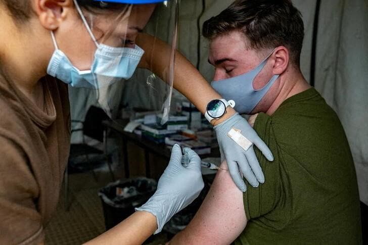 U.S. Marines and sailors with III Marine Expeditionary Force receive COVID-19 vaccines on Camp Foster, Okinawa, Japan, December 29, 2020. Picture taken December 29, 2020.  U.S. Marine Corps/Lance Cpl. Natalie Greenwood/Handout via REUTERS  THIS IMAGE HAS