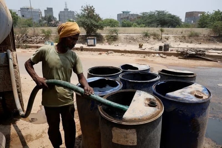 写真は猛暑の中、タンクに水をためる作業員。2024年5月、ニューデリーで撮影。REUTERS/Priyanshu Singh